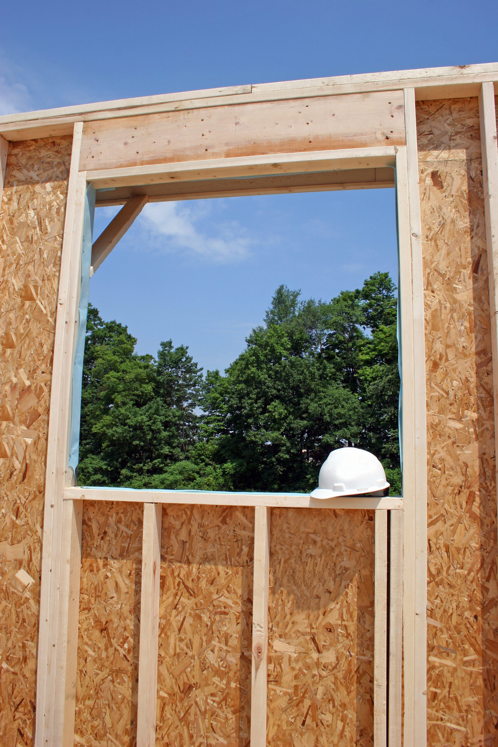 Window framing of new build with hard hat